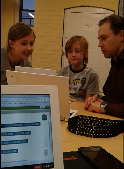 students and teacher work on app inventor